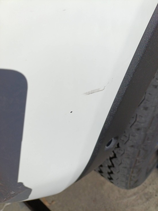 Close-up of a minor scratch found on the front bumper